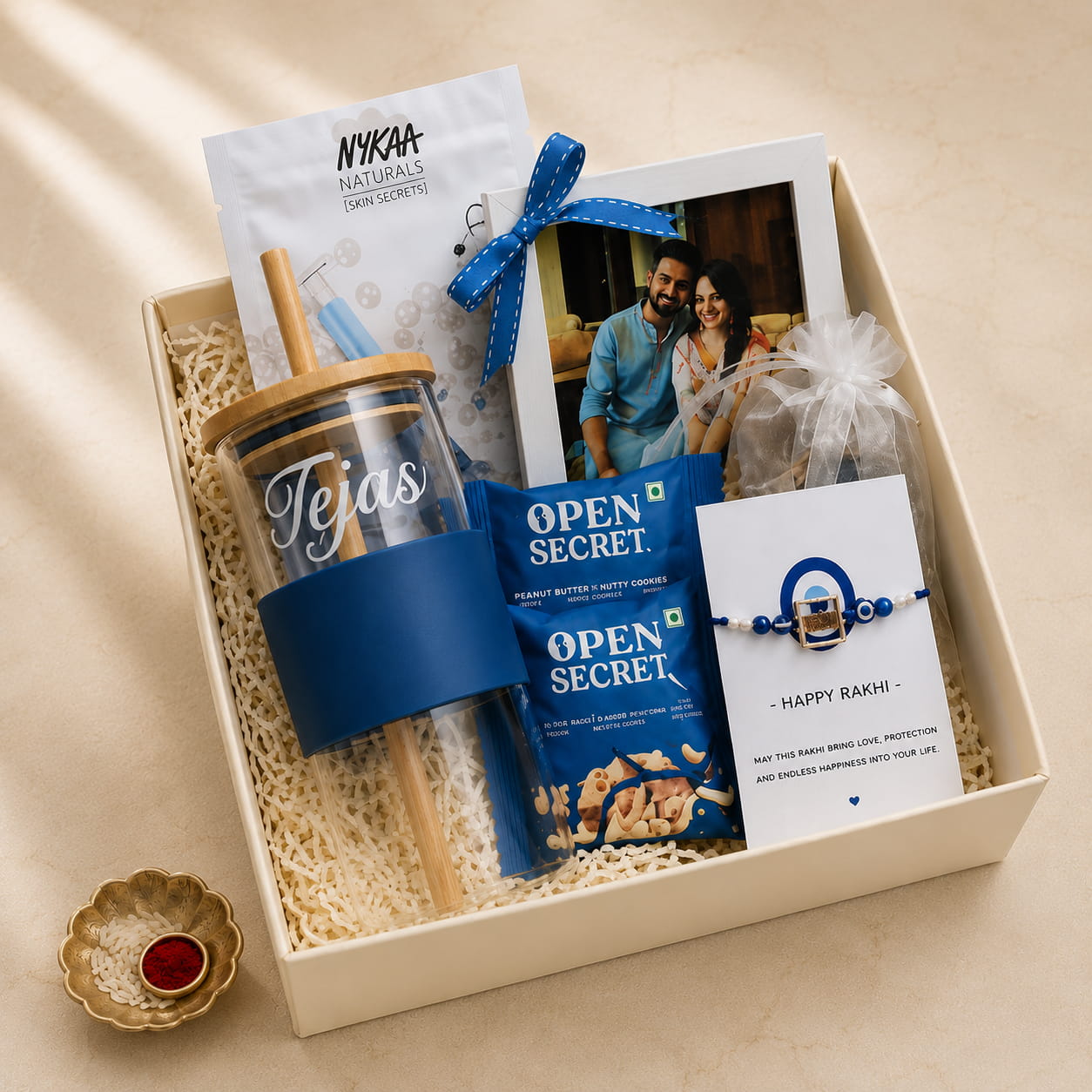 Personalized Celebration Rakhi Gift Hamper with custom sipper, photo frame, perfume, cookies and Evil Eye Rakhi