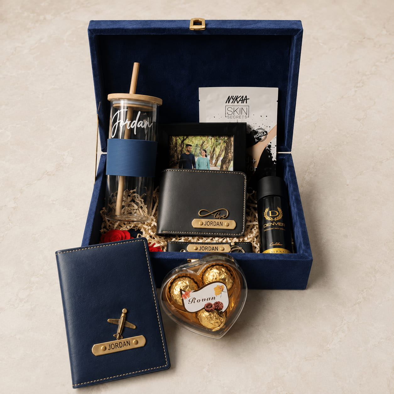 Personalized luxury men's gift hamper with velvet trunk box, custom wallet, passport cover, glass tumbler, keychain and premium gifting essentials.