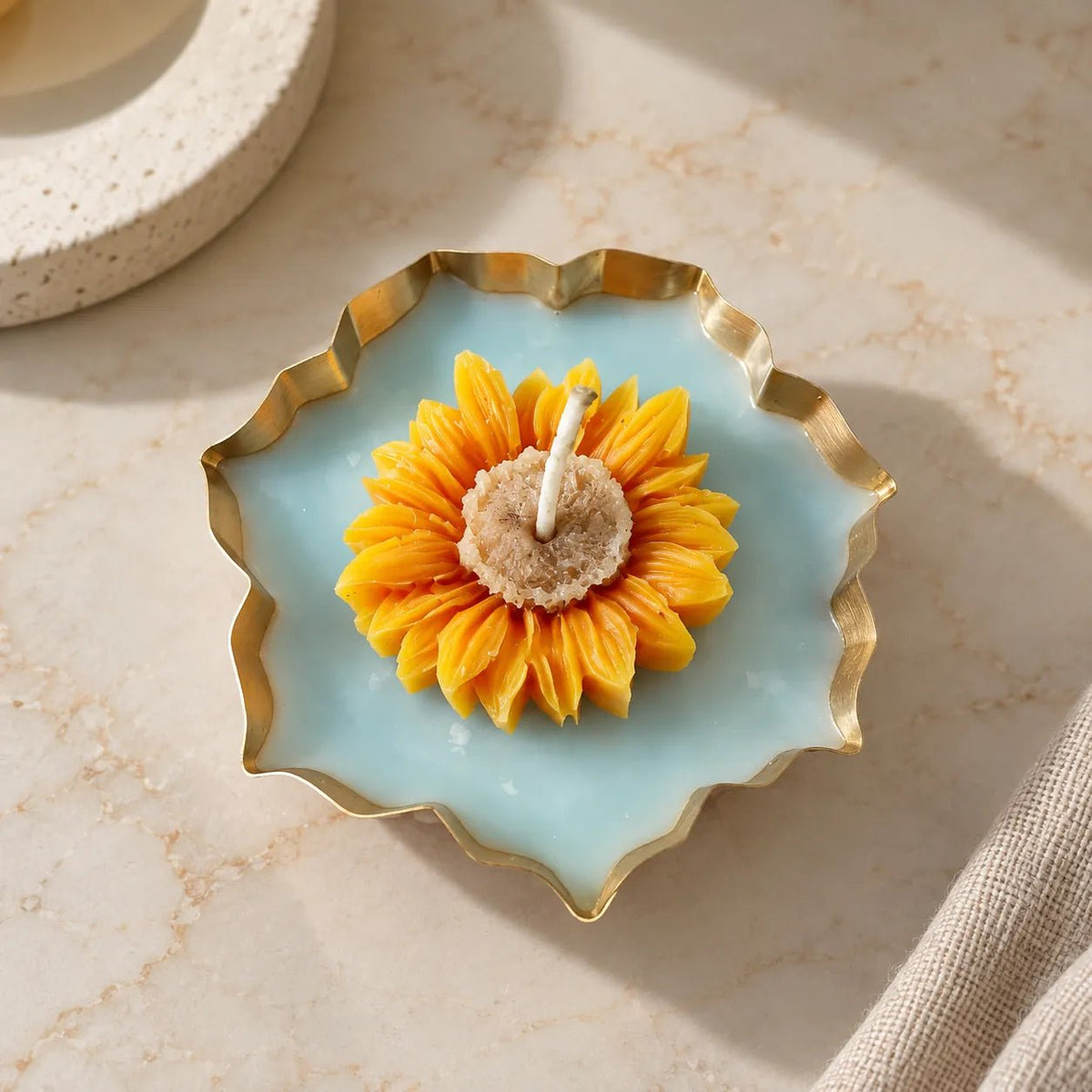 Sunflower Urli Candle with yellow floral candle and gold-finished urli