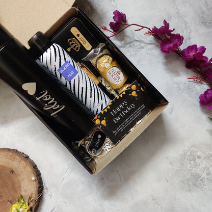 Personalized birthday gift hamper for him including LED bottle, wallet, chocolates, keychain, pen and greeting card.