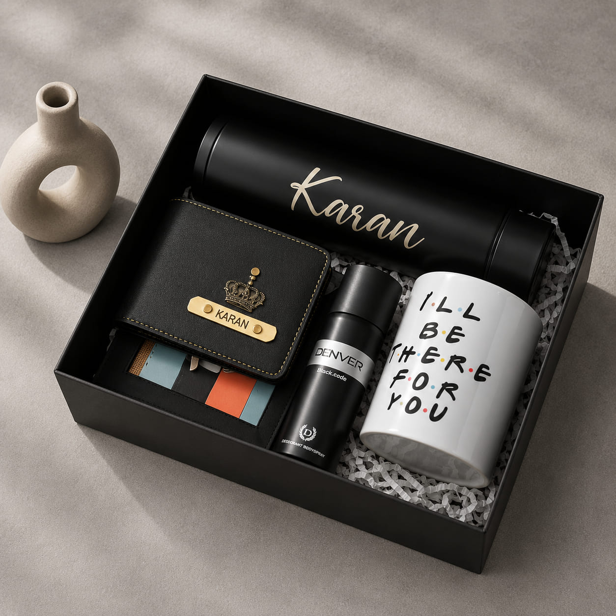 Personalized executive gift hamper for men with custom wallet, insulated bottle, coffee mug, and premium black gift box.