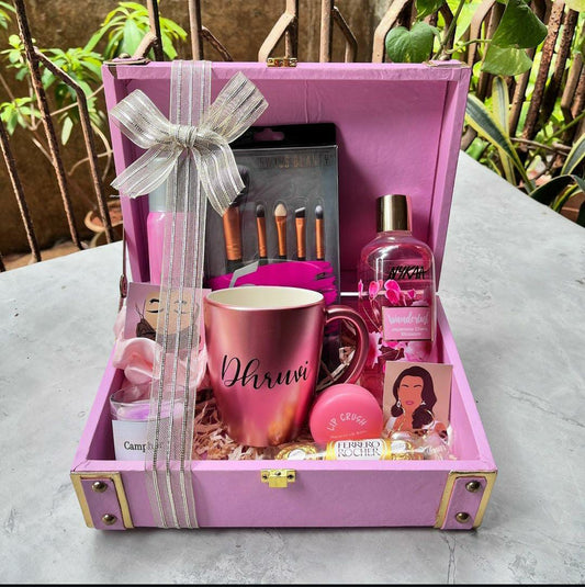 Personalized beauty and pamper hamper for women with custom mug, beauty essentials, chocolates and personalized pink trunk