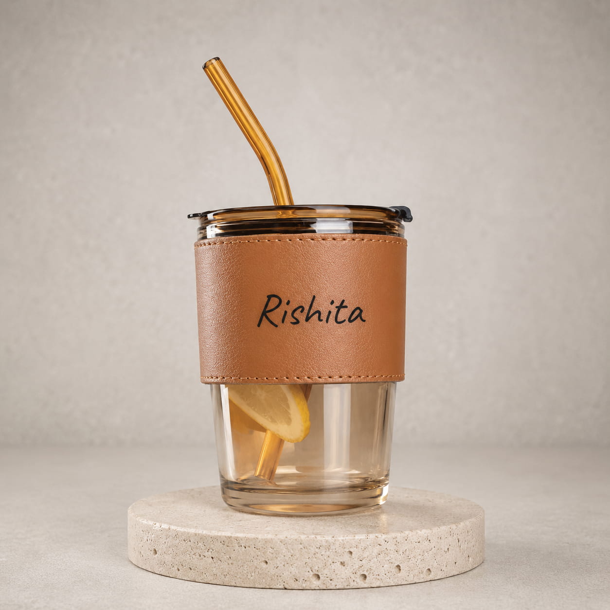 Personalized glass sipper tumbler with leather sleeve, reusable straw and custom name printing.
