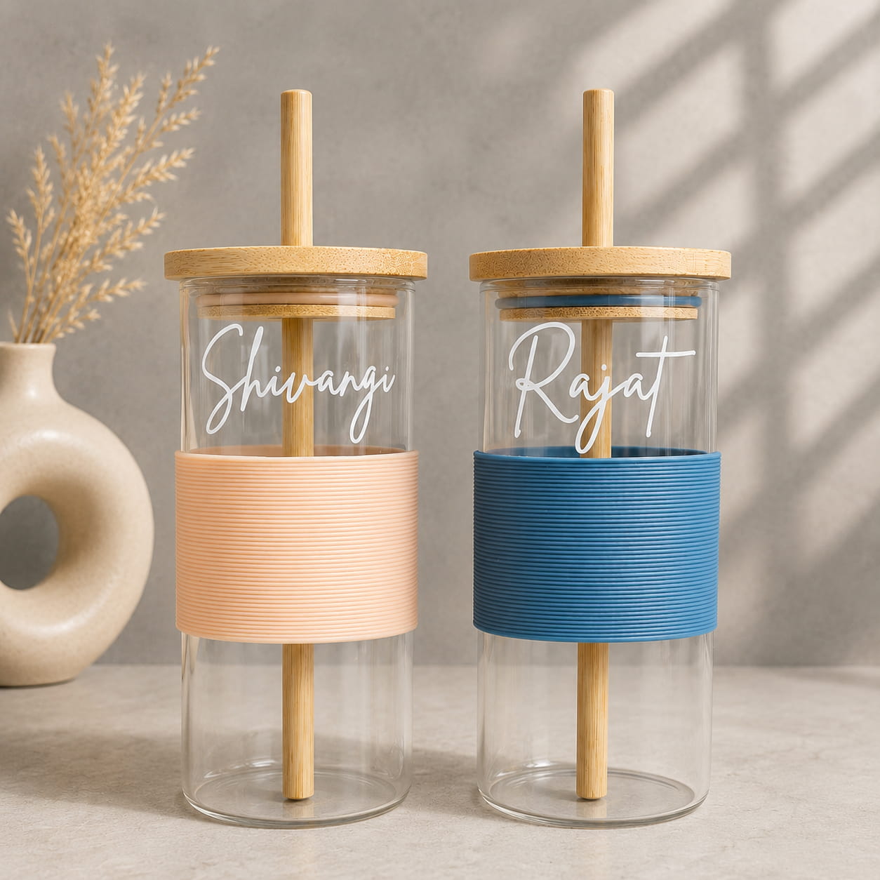 Personalized glass tumbler set of 2 with bamboo lids, reusable glass straws and silicone grip sleeves.