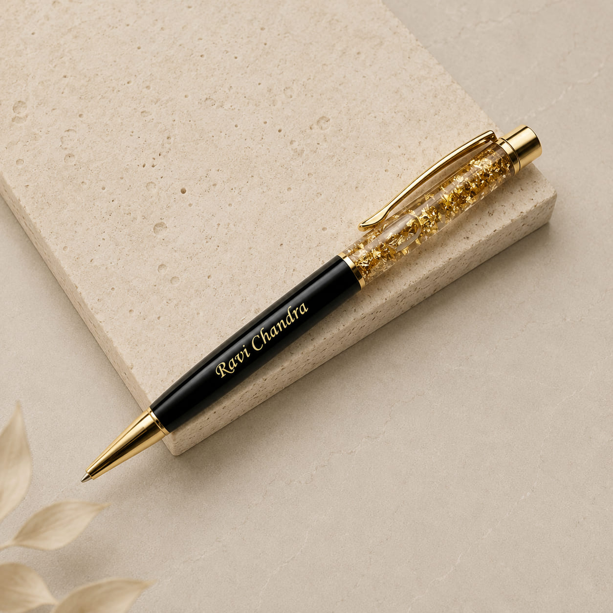 Personalized gold flake pen with custom name engraving.
