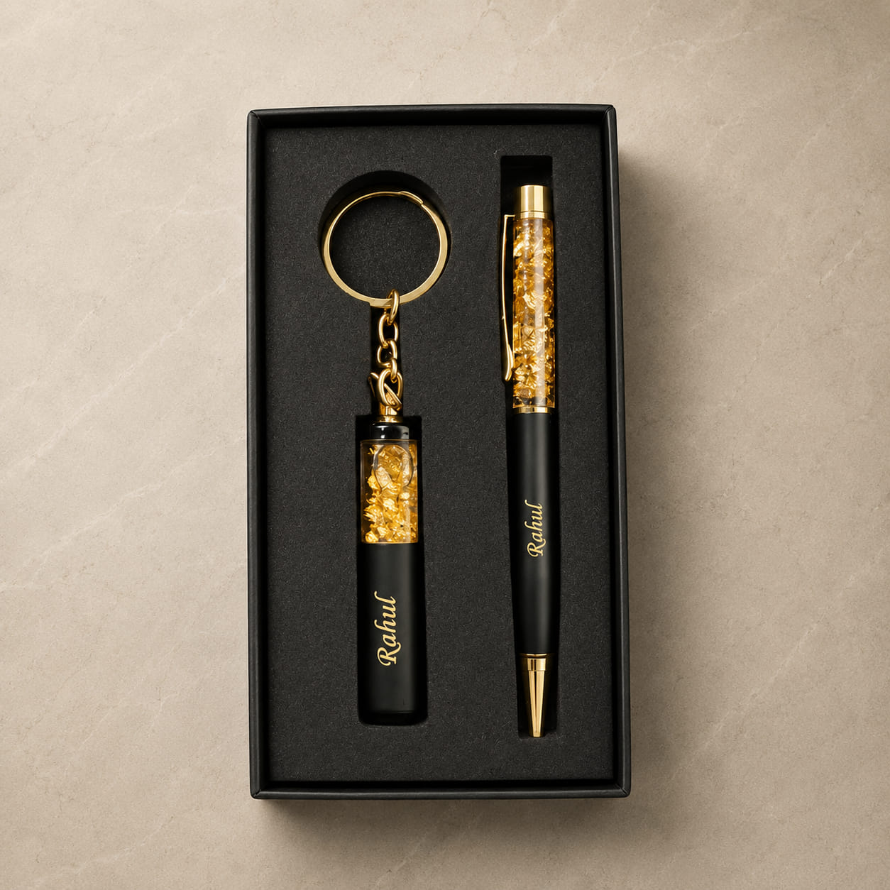 Personalized gold flake pen and matching keychain gift set with custom name engraving in a premium black gift box.