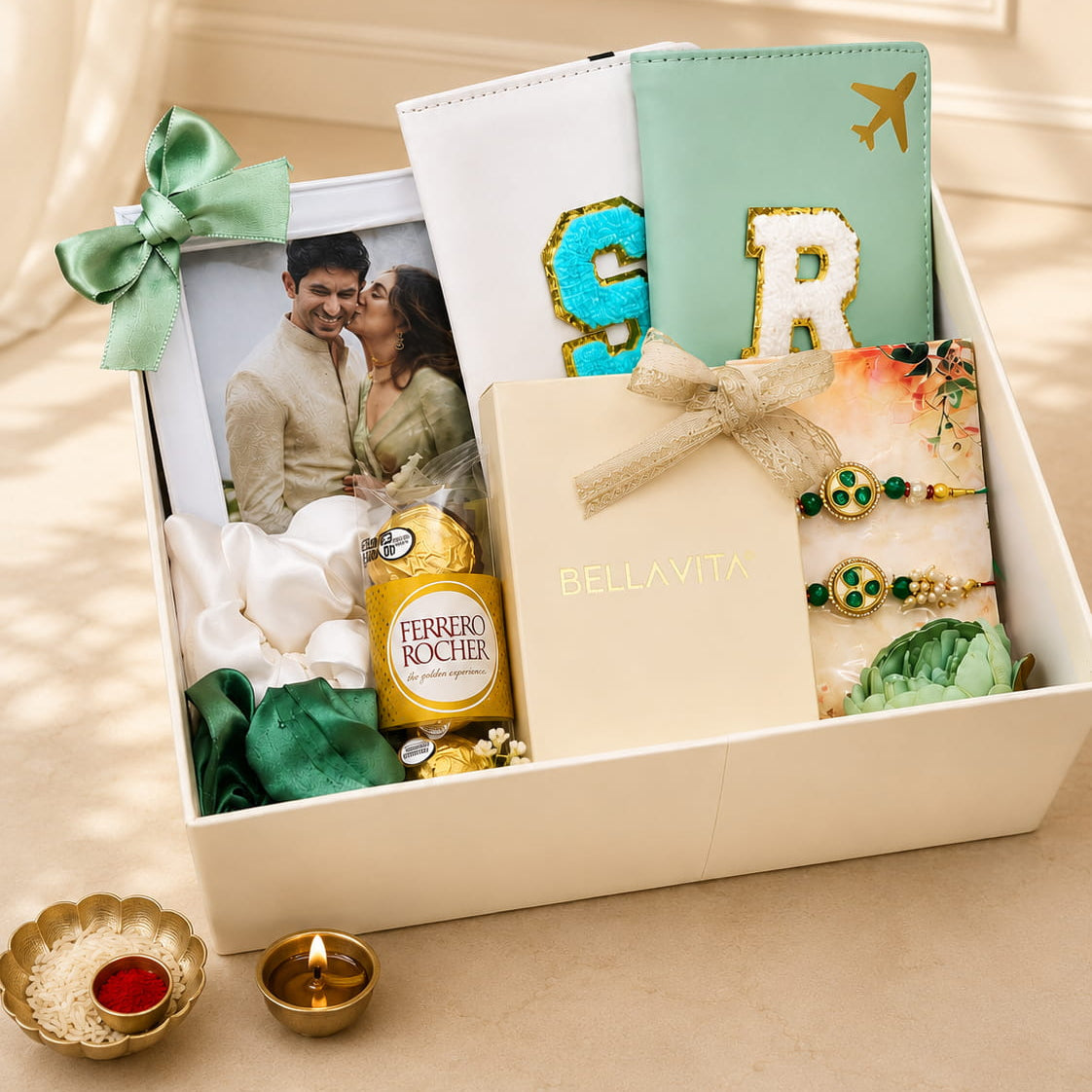 Personalized Keepsake Rakhi gift hamper with custom passport covers, photo frame, Bella Vita perfume set, Ferrero Rocher chocolates, scrunchies and Rakhi Lumba in a premium white gift box