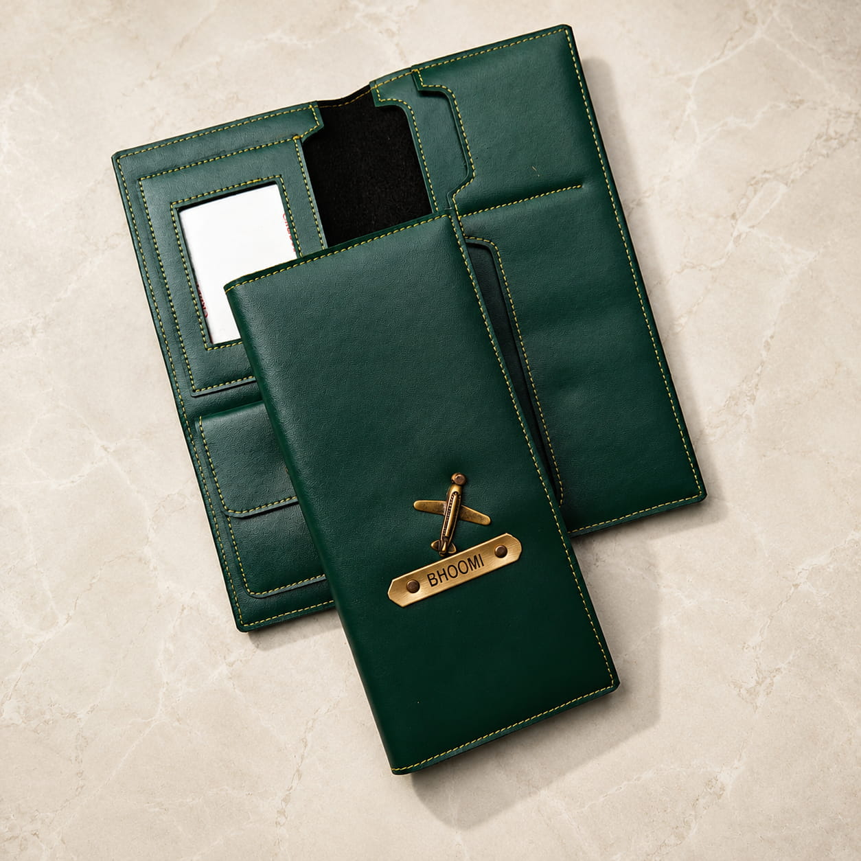 Personalized long passport organizer in green vegan leather with custom name plate and airplane charm.