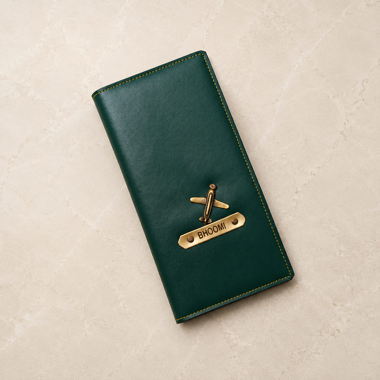 Personalized long passport organizer in green vegan leather with custom name plate and airplane charm.