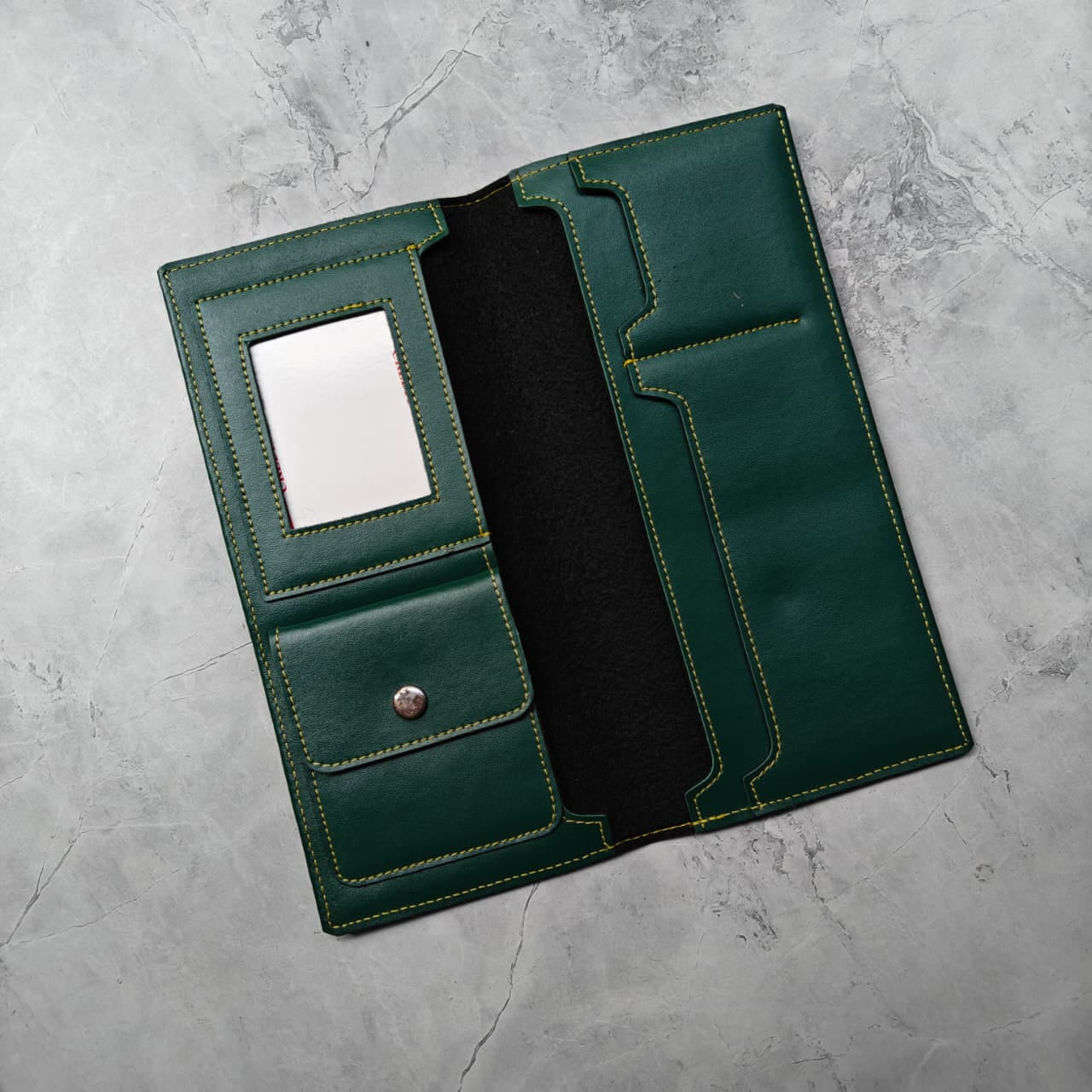 Personalized long passport organizer in green vegan leather with custom name plate and airplane charm.