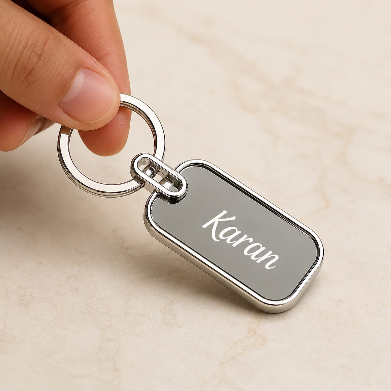 Personalized metal name keychain with custom engraving and polished silver finish.