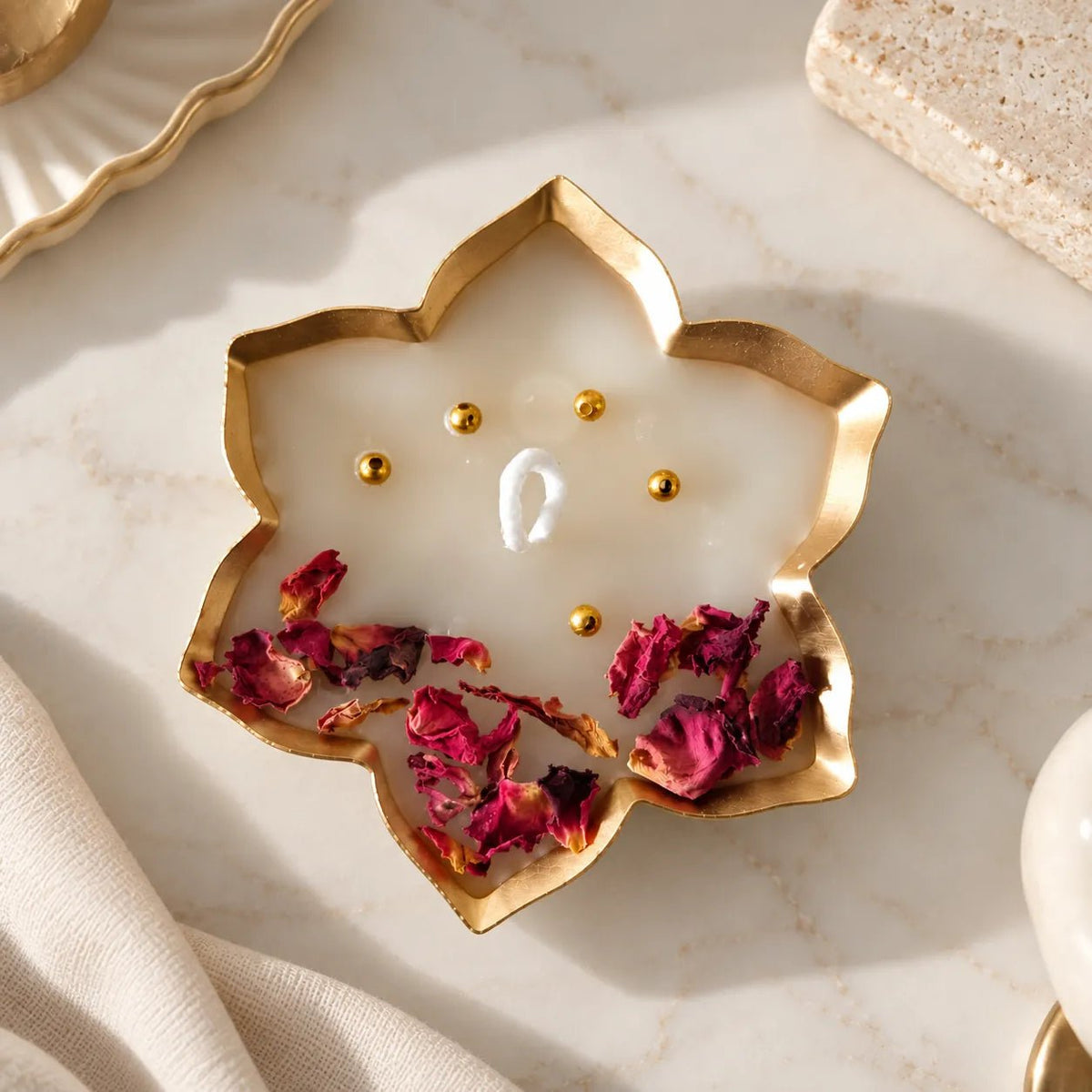 Rose Petal Urli Candle with golden floral metal urli and rose petals